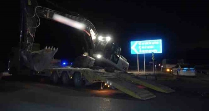 Deprem bölgesine giden tırın taşıdığı iş makinesi yola devrildi