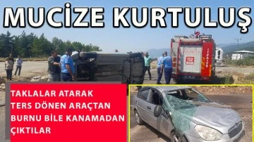 Taklalar atarak ters dönen araçtan burnu bile kanamadan çıktılar